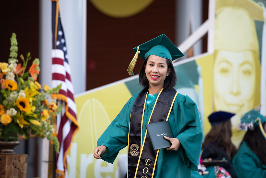 EOPS Student walking across the stage with diploma