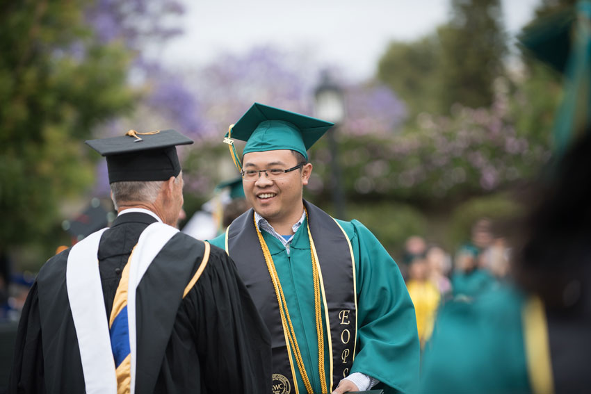 EOPS grad student talking to faculty at Commencement