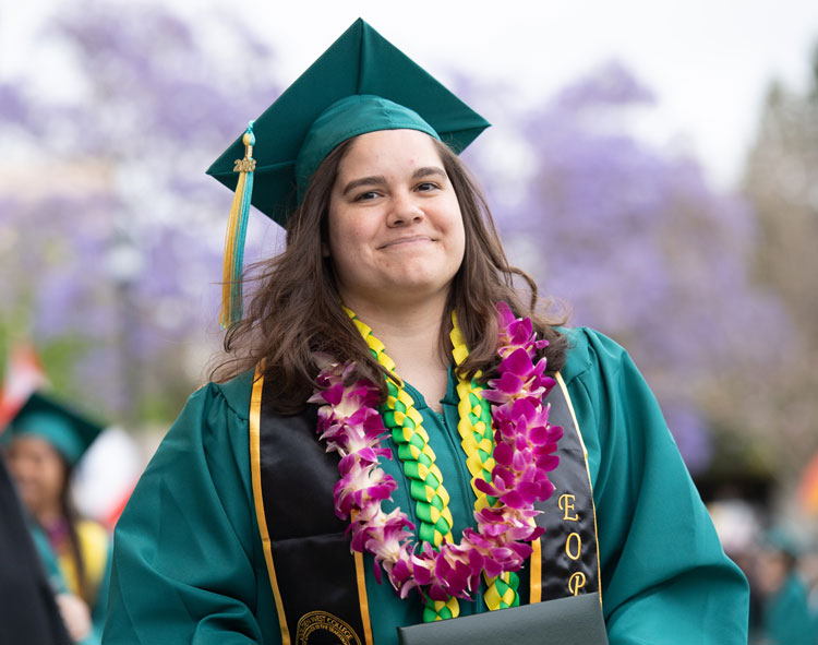 EOPS Graduate holding their diploma
